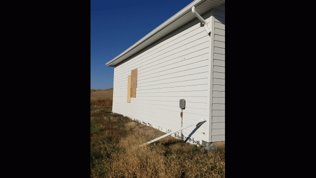 Windows boarded up after summer storm. Courtesy Photo
