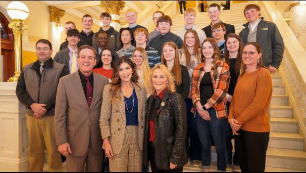1st row: Lt. Gov. Larry Rhoden, Governor Kristi Noem, and Sandy Rhoden. 2nd Row: Mr. Kelly Daughters, Mia Hermes, Madison Brooks, Tallyn Pederson, Shada Selby, and Mrs. Deanna Fischbach. 3rd row: Teancum Maxwell, Victor Ilensamni, Canyon King, Waycee Nelson, Kemper Holmes, Tristan Kennedy, Lanny Brooks, and Jaysee Jones. 4th row: Landon Schultes, Matthew Gray, Rylan Palmer, Jess Harper, Andrew Gifford, Brigg Price, Trey Fuller, and Cord Capp. Photo courtesy Mrs. Deanna Fischbach