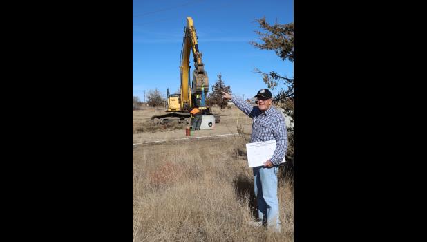 M.R. Hansen points to the cedar trees that surrounded the house that he grew up in. The house was taken out to make room for new lots for approximately 17 houses.