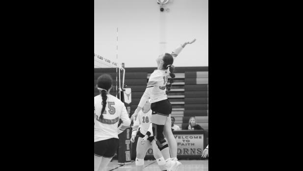 Reagan Grueb ... soaring above the net, to send the ball into Newell territory courtesy of setter Skylar Vig. The Longhorns won over the Newell Irrigators in their last home game of the regular season. Photo courtesy Alison Grueb