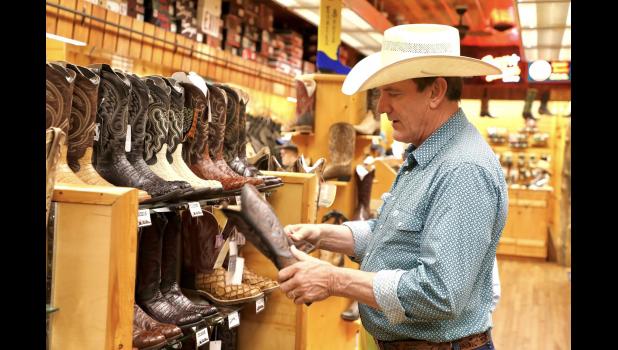 Governor Rhoden checks out the boots at Wall Drug while on his Open for Opportunity Tour. Courtesy Governor Larry Rhoden’s facebook page