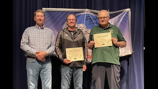 Honorees ... Mr. Doug Schauer and Mr. Craig Ness on stage with Mr. Bryan Carmichael who nominated them along with Mr. Mel Dutton and Coach Randi Faeth receiving certificates of recognition at Mitchell, SD. Photo courtesy Amie Schauer