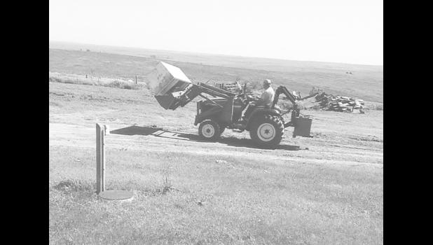 Brother-in-law Warren Melcher helps on cleanup. Photo by Elaine Buxcel