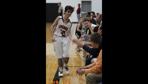 Davi Isaac ... receiving high fives from coaches adn teammates after making his first basket. Photo courtesy Amie Schauer