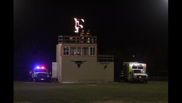 Proudly ... burning the F atop the announcers box at the football field, accompanied by Faith Fire and Ambulance crew members. Photo courtesy FHS Journalism/Yearbook