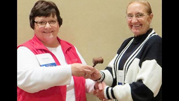 Past SDML President Jeanne Duchscher, left, passes the gavel to newly elected President Meri Jo Anderson after Anderson's election in Aberdeen.