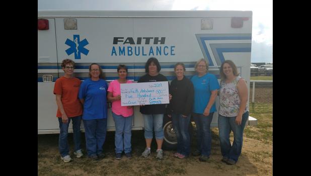Faith Ambulance Service ... receiving a check for $500.00, with Faith Area Community Foundation board member Shalyn Hawley. Courtesy photo