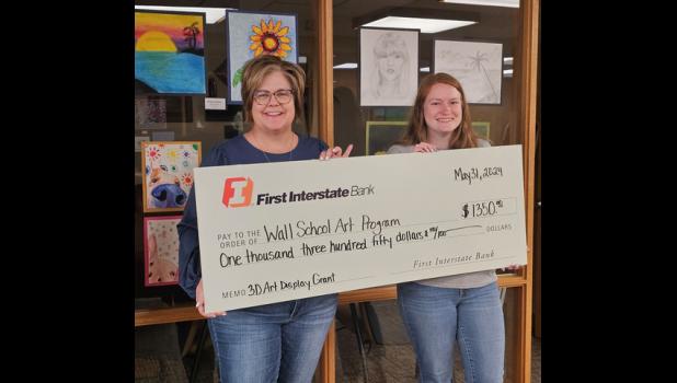 Pam Johnson with the First Interstate Greater Wall Fund presents a $1,350 grant to Jacey Hays, Wall School Art Teacher, for their 3D art display at the Wall School Art Program. Courtesy Photo