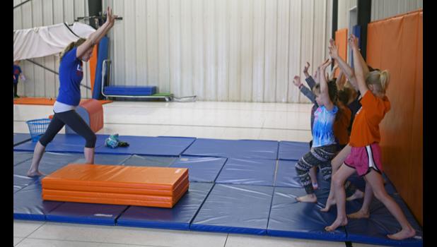 Students practice their lunges at the beginning of class.