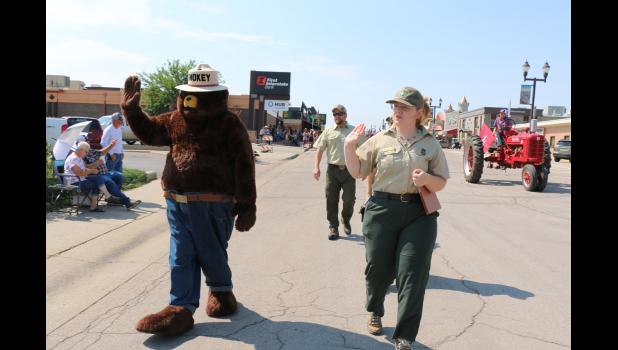 Left to right: Smokey Bear, District Ranger Carl Frey, Madisen Grenstiner; Ranger Jessie Lackey is behind Madisen Courtesy Linda M. Hiltner, National Grasslands Visitor Center