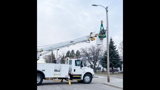 City Crew ... hanging the street lights. Courtesy Photo