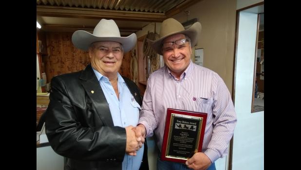 Tony Heinze congratulates Doug Dietterle... auctioneer from Meadow, South Dakota, on winning the Tony Heinze Award at the Greater Midwest Livestock Auctioneers Championship. Photo courtesy Gayla Piroutek