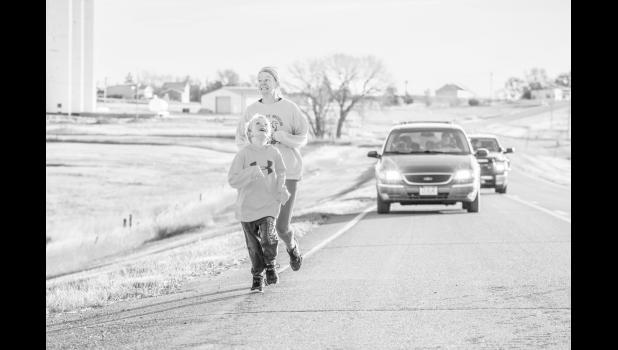 Mason and his mom, Abby Martinez shortly into the 10 mile run. Photo by Barb Hockenbary