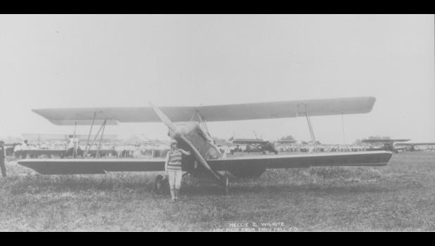 Nellie standing beside her plane, an Alexander Eaglerock biplane. Photo courtesy South Dakota State Historical Society – State Archives