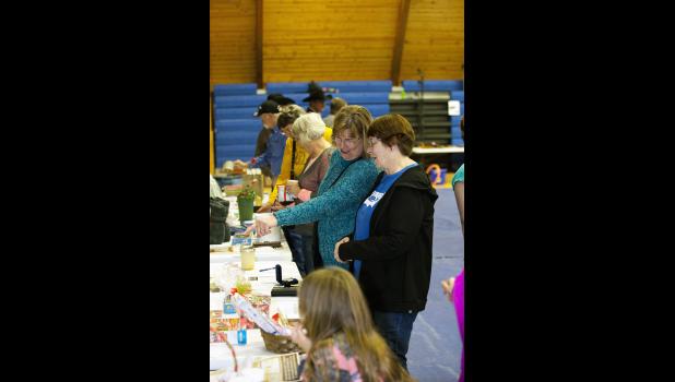 Photo by Barb Hockenbary. Local friends and family browse the tables showcasing hundreds of donated items to be auctioned at the event.