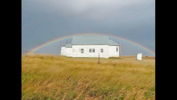 After the storm ... this complete rainbow created a halo effect over the Church. Although the sky is dark, the sun shone brightly on the Church itself. Greg Fisher, one of the event volunteers, said, “It’s as if God was Blessing Our Lady of Victory Catholic Church, for her 100 years of service to the Plainview area and Western South Dakota”. Photo courtesy Amy Ulrich