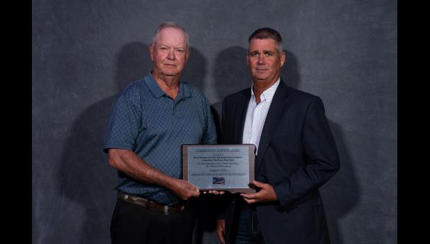 Doug Hauk and Matt Reedy accept the Community Service Award on behalf of the Trenchard Scholarship founders and Board of Trustees. Courtesy Photo