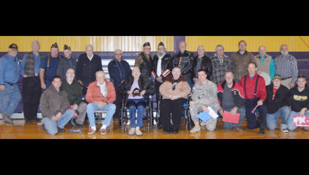 Four of the five branches of the U.S. military were represented at the New Underwood Veteran's Day celebration. Back row from left are Buzz Johnson, Army, Don Krog, Air Force, Ron Racicky, Navy, Wes Reeves, Army National Guard, Melvin Fernau, Army, Gene Crosbie, Army National Guard, Ken Karp, Army, Chuck Dockter, Army, Bill Winegar, Army, Don Weibers, Army, Dennis Anderson, Navy, Casey Tippmann, Army, Ronald Miller, Army and Larry Broomfield, Air Force. Front row from left are Matthew Emmons, Air Force, Dav