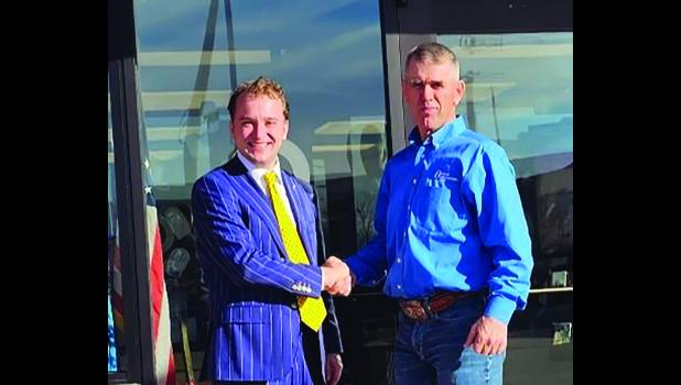 William “Willie” Hustead (left) receives a warm welcome from Brett Blasius of First Interstate Bank, Wall. The Hustead Law office is operating their law practice out of an office inside the local bank building.