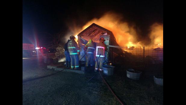 Members of the Murdo Volunteer Fire Department on scene of the fire.