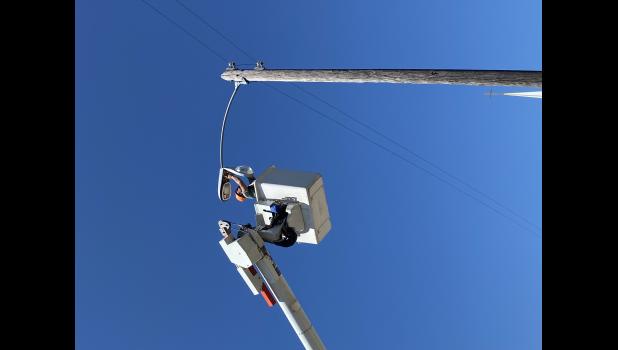 City Foreman Jon Collins … replacing one of the older street lights for the LED version. Courtesy photo