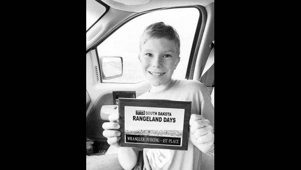 Jesse Schoon holds up his 1st place plaque for the rangeland days contest. Courtesy Photo