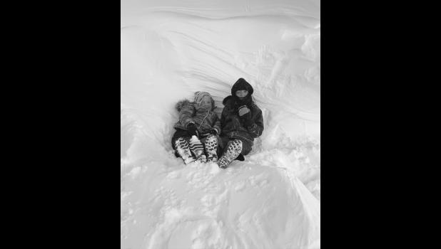 Evelyn Tatum and Maggie Miller chillin’ in a big snow drift. Photo courtesy Becca Miller