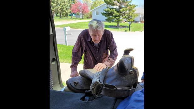 It was almost as if ... Ed DeKnikker saw an old friend after more than 70 years when he saw his saddle from a west river cattle round up decades before. Photo courtesy Potter County News