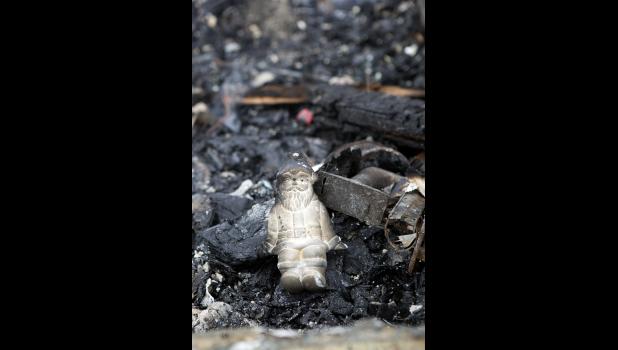 A Santa Claus figurine found amongst the ashes.
