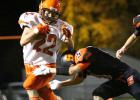 Trying to avoid at tackle by a Scotland Highlander, Deontae Thorn carries the ball for the Philip Scotties.