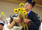 Nancy Haigh Phillip High School graduates have a tradition of giving flowers to family and other loved ones. Riley Heltzel hugs his sister while delivering his.