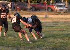 Matthew Gray and Brigg Pice … rushing to help their teammate tackle Dupree Tiger running the ball. Photo courtesy Alison Grueb