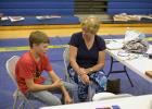 Matthew Birkeland interviewed by judges during Achievement Days.