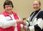 Past SDML President Jeanne Duchscher, left, passes the gavel to newly elected President Meri Jo Anderson after Anderson's election in Aberdeen.