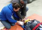 Vanessa Hight plays patient to Lacie Campbell and Chris Letellier as they practice spinal immobilization and backboarding skills.