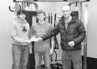 L-R; Tanner Willert and Mathew Birkeland graciously accept a check for the Community Weight Room from Jones County Community Foundation member Jim Butt. Courtesy photo