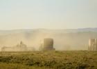 Despite the high winds and dust, two balers and two rakes soon had the downed hay in this field first in neat windrows, then baled. 