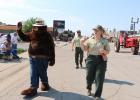 Left to right: Smokey Bear, District Ranger Carl Frey, Madisen Grenstiner; Ranger Jessie Lackey is behind Madisen Courtesy Linda M. Hiltner, National Grasslands Visitor Center