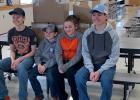 Brigg Price, Koyle King, Cashley King, and Brayden Price … stop for a photo while unloading the processed beef donated to the Faith School. Photo courtesy Faith School