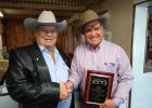 Tony Heinze congratulates Doug Dietterle... auctioneer from Meadow, South Dakota, on winning the Tony Heinze Award at the Greater Midwest Livestock Auctioneers Championship. Photo courtesy Gayla Piroutek
