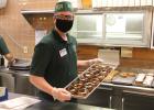 Wall Drug employee and donuts