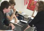 Jacqueline Myers offers friendly instruction to Dalton Madsen and Nate Ludovissie during English I.