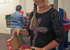 Lavonne Kinsley, head of the Operation Christmas Child program at Community Bible Church fills a shoe box with items in preparation to be sent out.