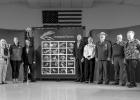 The dedication ceremony was held Friday, May 19th in Wall, SD. Pictured above: Becky Dewitz, Martha Williams, Joel Sartore, Peter Pastre, Dr Jill Tiefenthaler, Eric Veach, Jack Isaacs and Mary Williams stand around the new endangered species stamps. The pane of stamps showcase photographs of endangered animals found within the 50 states and American territories plus two North American species living near the U.S. Borders. Photo courtesy of Mama Law Photography