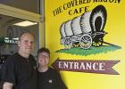 Owners of the Covered Wagon Cafe Russ and Missy Wilbur pose in front of the freshly painted cafe entrance.